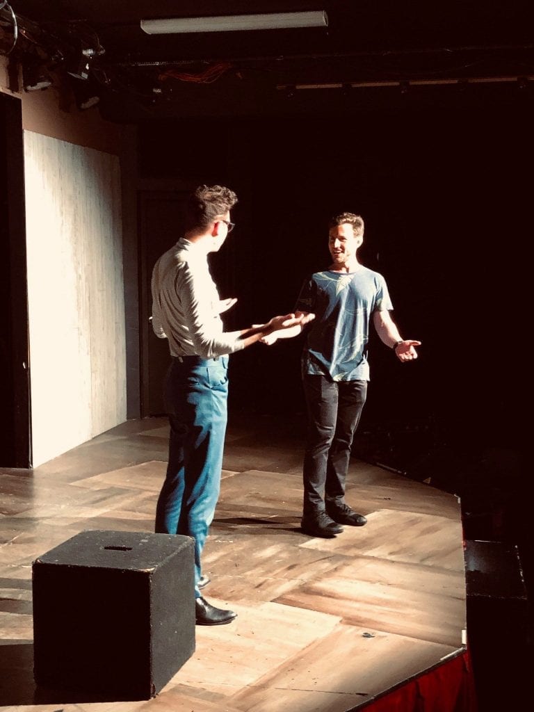 Mike performing improv comedy stage with buddy